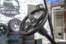 Black golf cart steering wheel.
