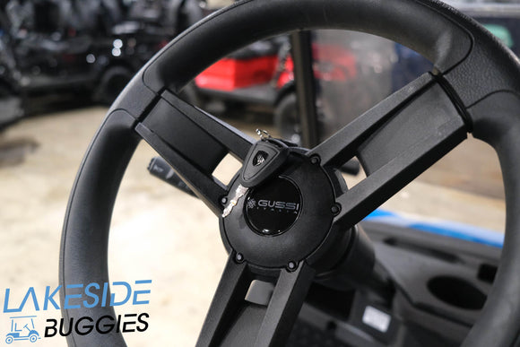Black golf cart steering wheel.