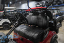Maroon golf cart with black diamond-stitched seats.