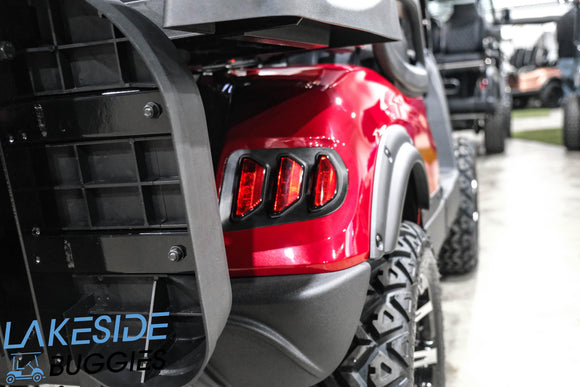 Red golf cart with off-road tires.