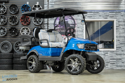 Blue golf cart with custom wheels.