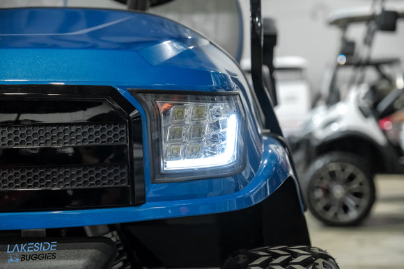 Blue golf cart with LED headlight.