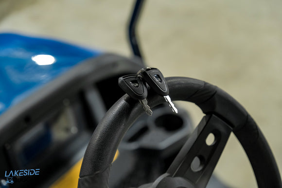 Golf cart steering wheel with keys.