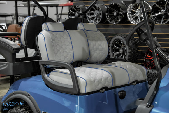 Blue golf cart with patterned seats.
