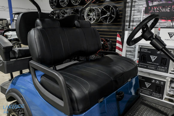 Blue golf cart with black seats.