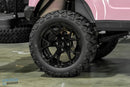 Black off-road tire and rim.