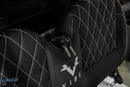 Black seat with white stitching and keys.