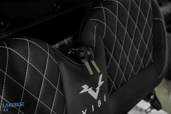 Black seat with white stitching and keys.