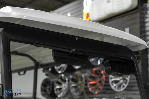 Golf cart roof with speakers.