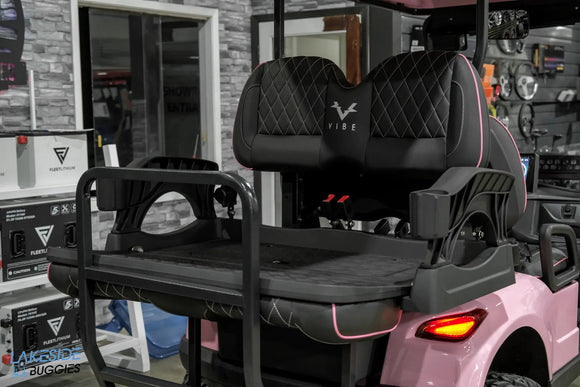 Pink golf cart with black seats.