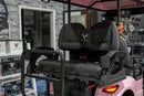 Pink golf cart with black seats.