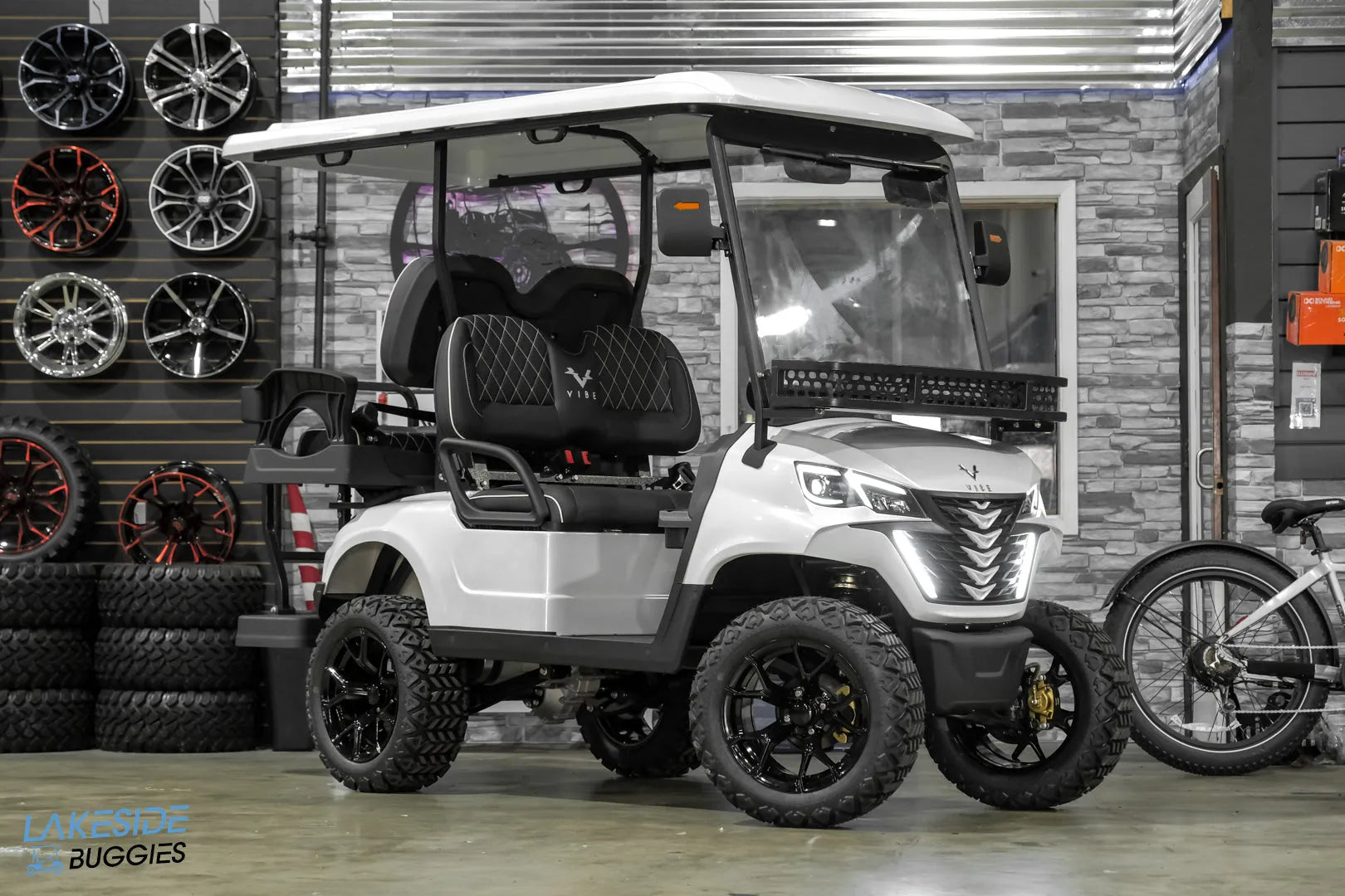 White golf cart with black wheels.