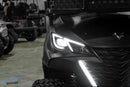 Black golf cart with illuminated headlights.