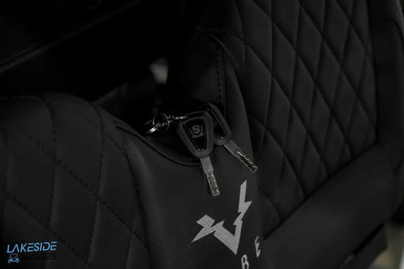 Black gaming chair with keys in pocket.