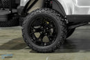 Black off-road tire and rim.