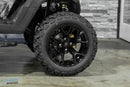 Black off-road tire and rim.