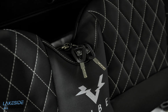 Black quilted chair with keys.