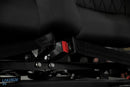 Black seat with seatbelt.