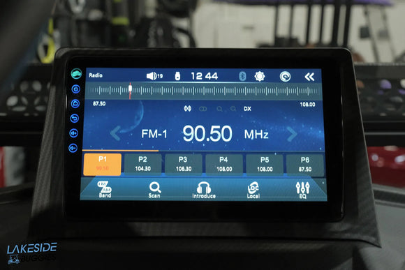 Car radio display showing FM frequency.