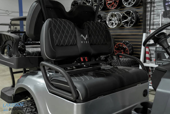 Gray golf cart with black seats.