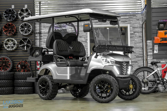 Silver golf cart with black wheels.