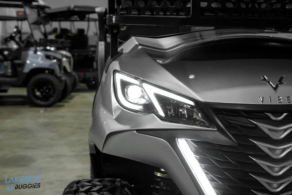 Silver golf cart with illuminated accents.