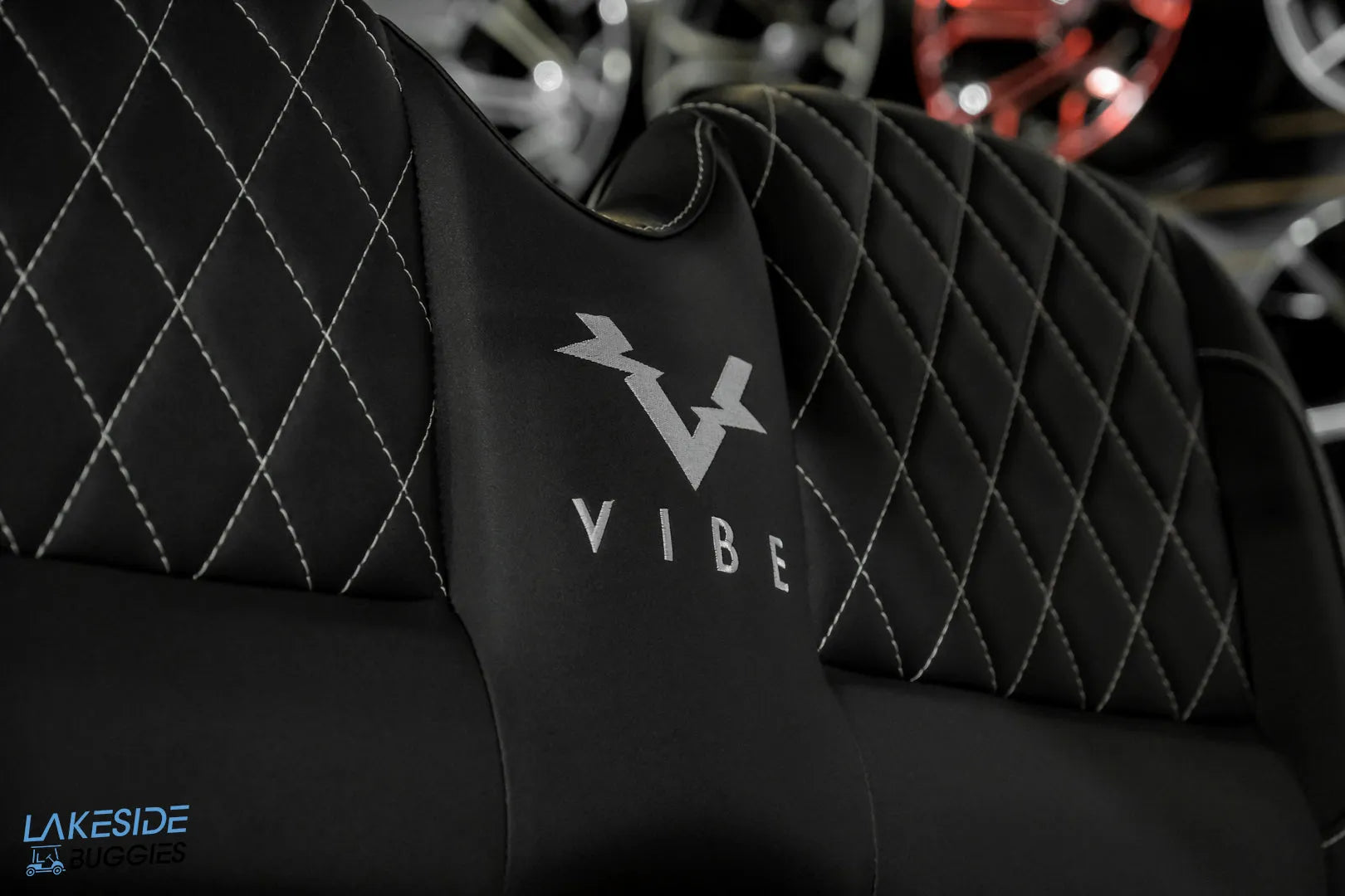 Black leather chair with diamond stitching.