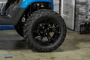 Black off-road tire and rim.