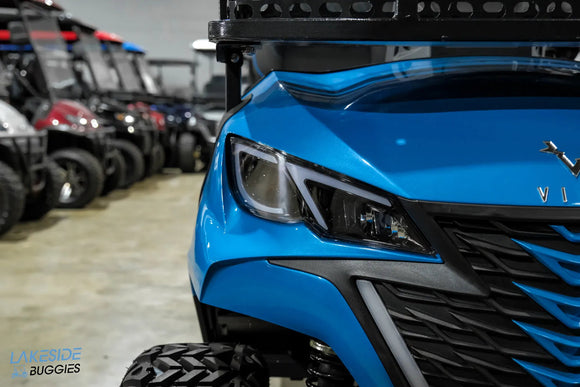Blue golf cart with modern headlights.
