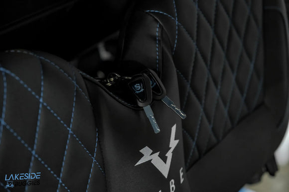 Black gaming chair with keys in pocket.