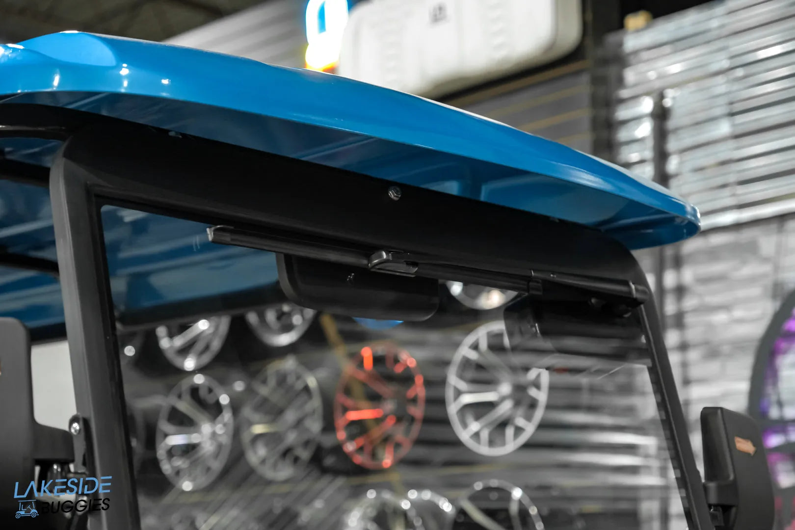 Blue golf cart roof with speakers.