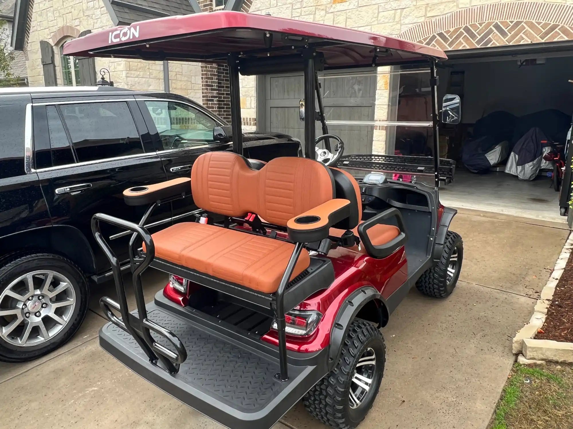 Maroon golf cart with tan seats.
